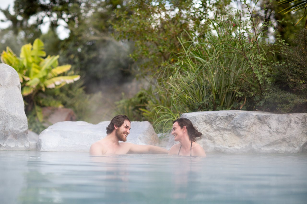 Couple relax in hot pool